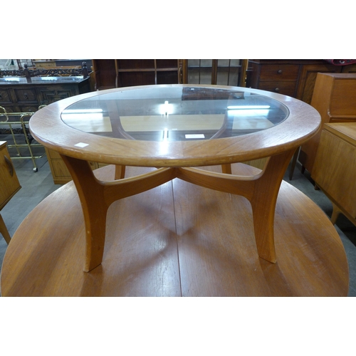 64 - A circular teak and glass topped coffee table