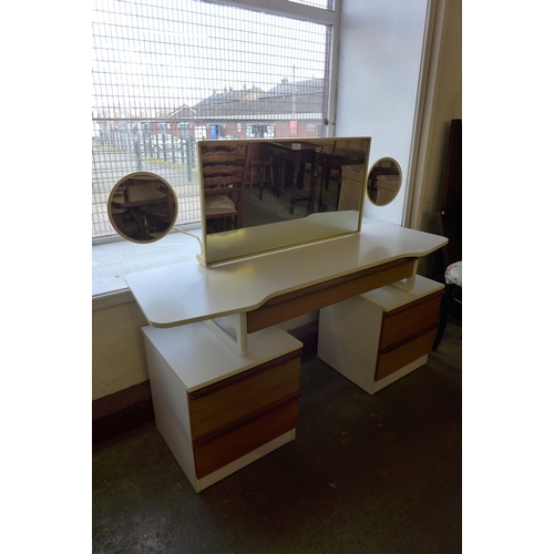 85 - A teak and white laminate dressing table and stool