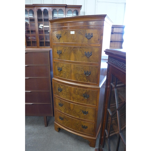 95 - A George III style walnut bow front chest of drawes