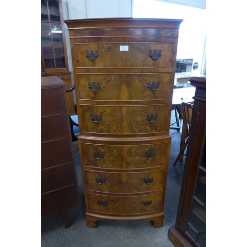 95 - A George III style walnut bow front chest of drawes