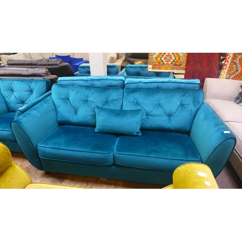 1334 - A teal velvet button back three seater sofa