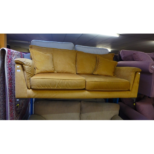 1596 - A turmeric velvet three seater sofa - marked