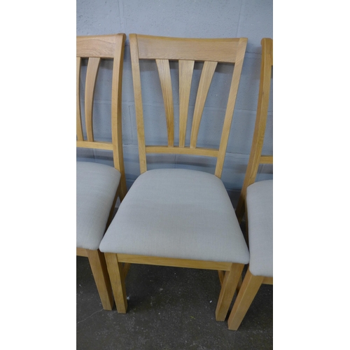 1414 - A set of six oak dining chairs with light grey upholstered seats