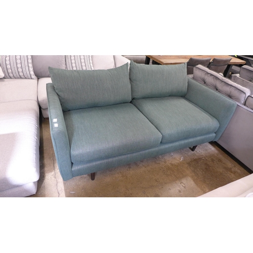 1458 - A forest green textured weave three seater sofa