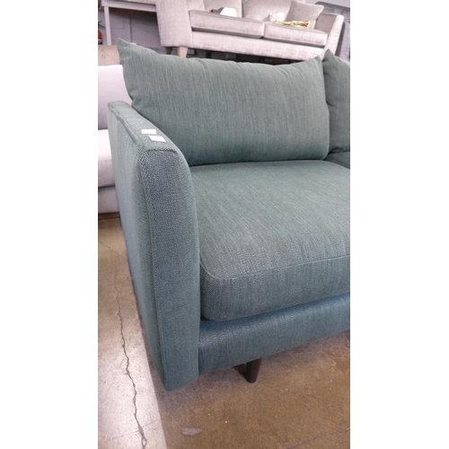 1458 - A forest green textured weave three seater sofa