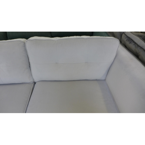 1459 - A stone grey velvet upholstered pinched back three seater sofa