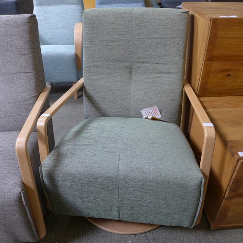 1593 - A Yoko Vista green upholstered swivel rocking chair RRP £999