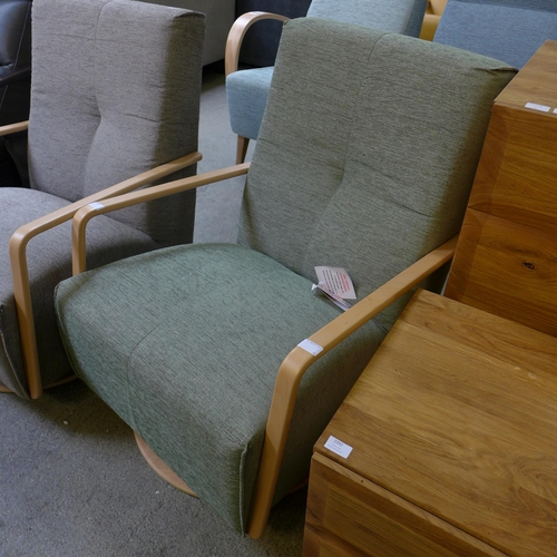 1593 - A Yoko Vista green upholstered swivel rocking chair RRP £999