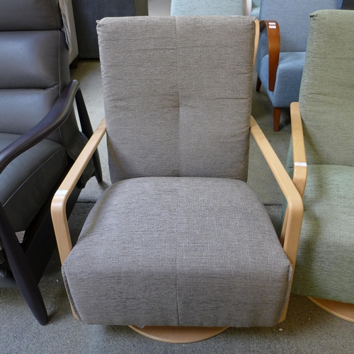 1594 - A Yoko vista grey upholstered swivel rocking chair RRP £999