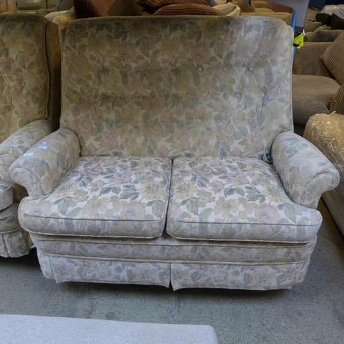 1597 - A floral patterned upholstered two seater sofa and an armchair with footstool