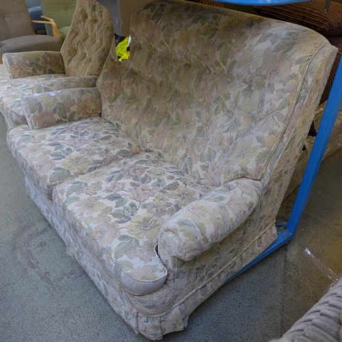 1597 - A floral patterned upholstered two seater sofa and an armchair with footstool