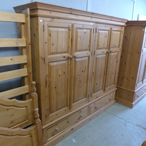 1656 - A pine four door, two drawer wardrobe