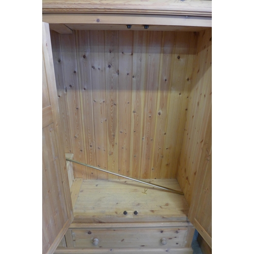 1656 - A pine four door, two drawer wardrobe