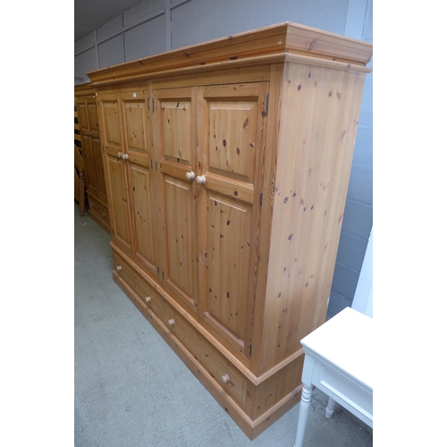 1657 - A pine four door, two drawer wardrobe