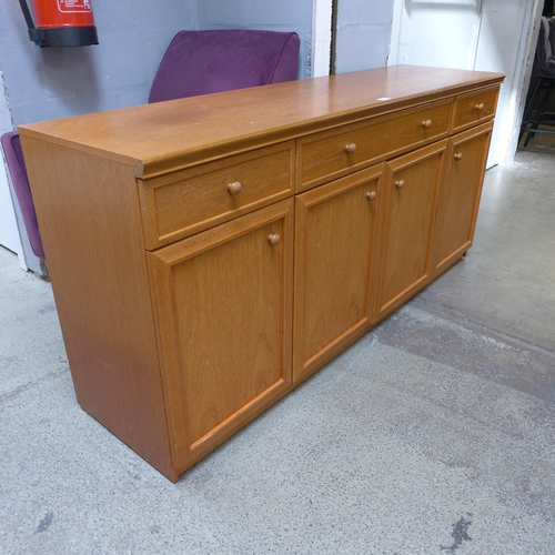 1661 - A teak four door, three drawer sideboard