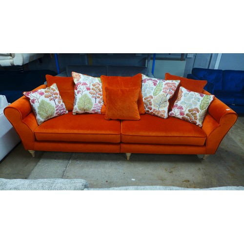 1332 - A metallic orange upholstered four seater sofa with patterned scatter cushions