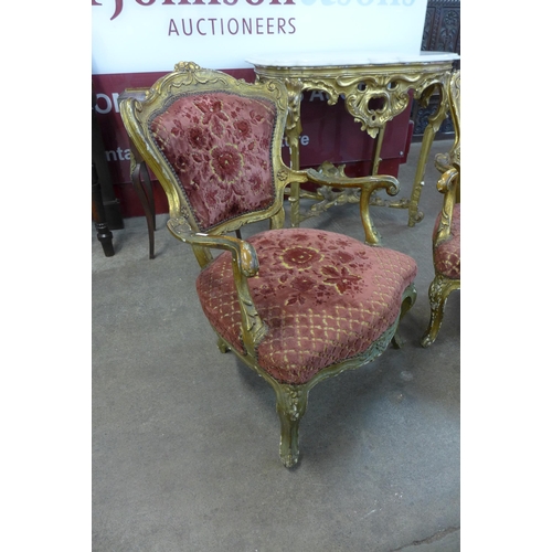 156 - A pair of French Louis XIV style carved giltwood and fabric upholstered fauteuil chairs