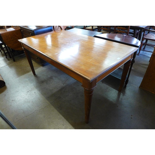 242 - A walnut dining table