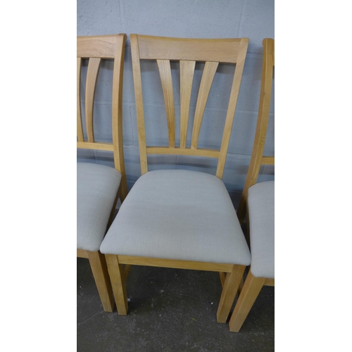 1405 - A set of six oak dining chairs with light grey upholstered seats
