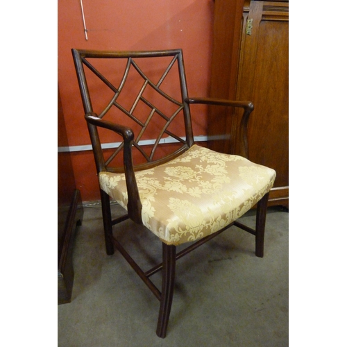 107 - A George III style mahogany cockpen armchair