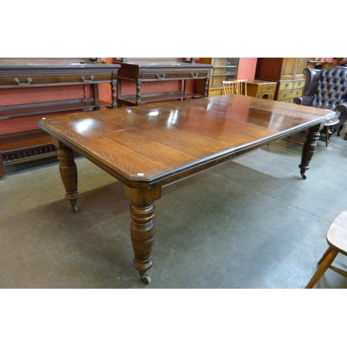 111 - A Victorian oak extending dining table
