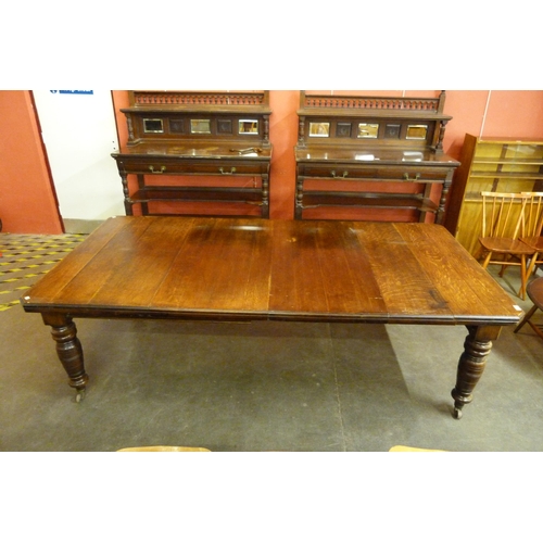 111 - A Victorian oak extending dining table