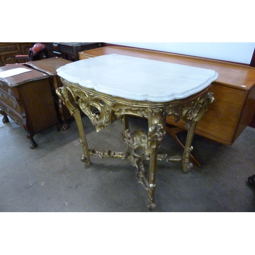 118 - An Italian Rococo style carved giltwood, gesso and marble topped console table