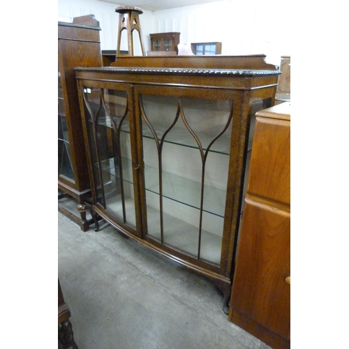 122 - An oak bow front two door display cabinet