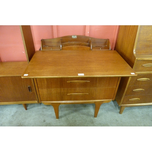 13 - A Jentique teak metamorphic desk /chest of drawers
