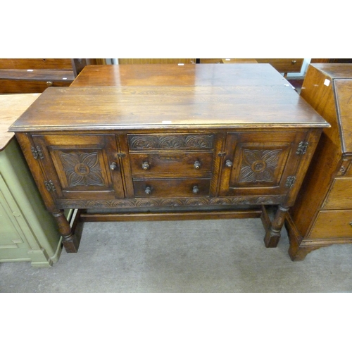 133 - A 17th Century style carved oak sideboard