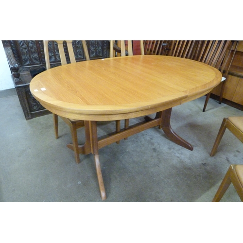 17 - A Nathan teak extending table and four chairs
