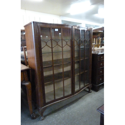 171 - A mahogany serpentine two door display cabinet