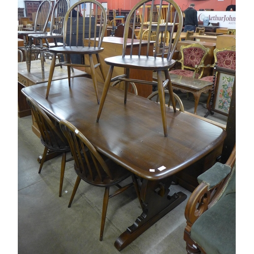 200 - An Ercol Golden Dawn elm refectory table and six Windsor chairs