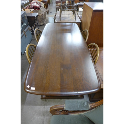 200 - An Ercol Golden Dawn elm refectory table and six Windsor chairs