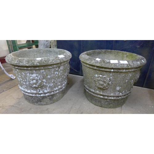 276 - A pair of concrete garden urns