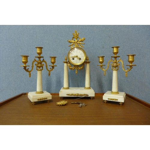 313 - A 19th Century French gilt metal and white marble clock garniture