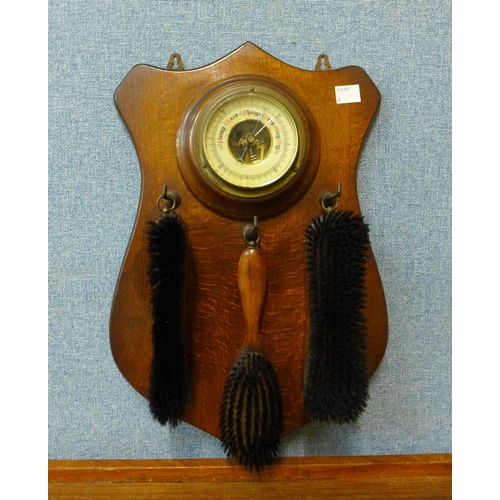 314 - An oak wall hanging aneroid barometer/brush set