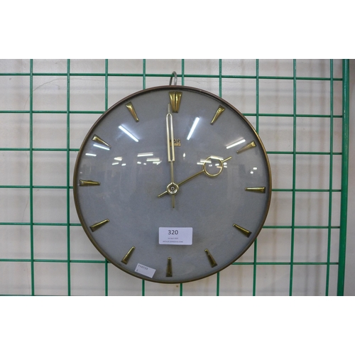 320 - A vintage UPG Halle circular brass wall clock