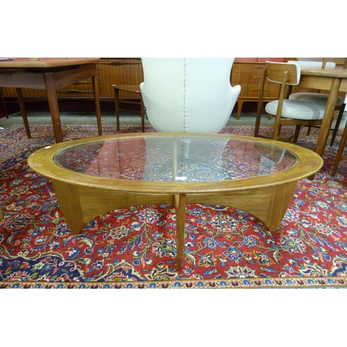 4 - A G-Plan Astro teak and glass topped oval coffee table