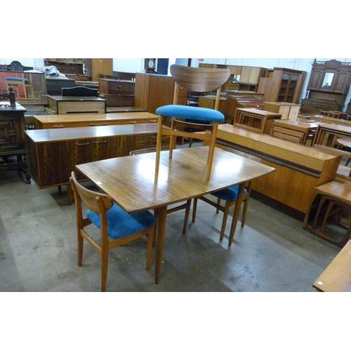 44 - A Morris of Glasgow walnut dining table and four chairs
