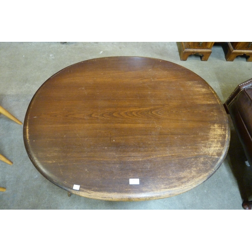 50 - An Ercol Golden Dawn elm and beech oval Windsor coffee table