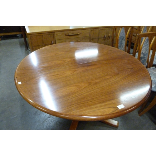 59 - A circular rosewood effect extending dining table