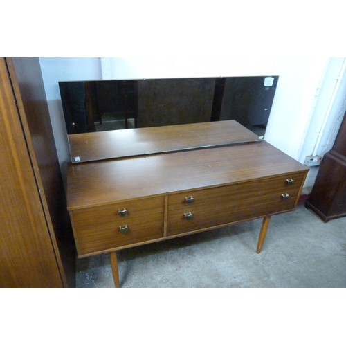 65 - An Avalon teak three piece bedroom suite, comprising; a dressing table, wardrobe and a bedside cupbo... 