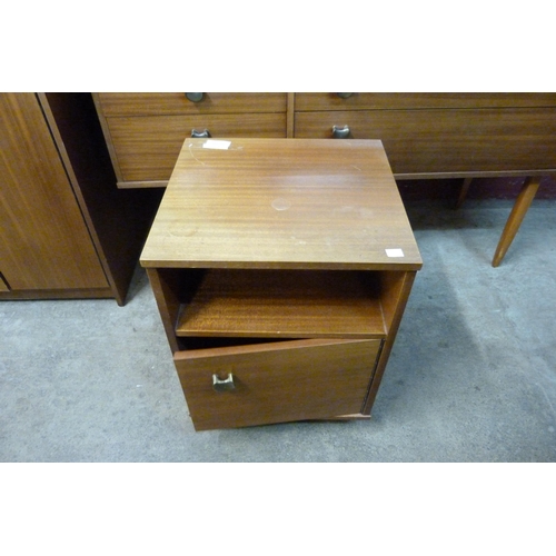 65 - An Avalon teak three piece bedroom suite, comprising; a dressing table, wardrobe and a bedside cupbo... 