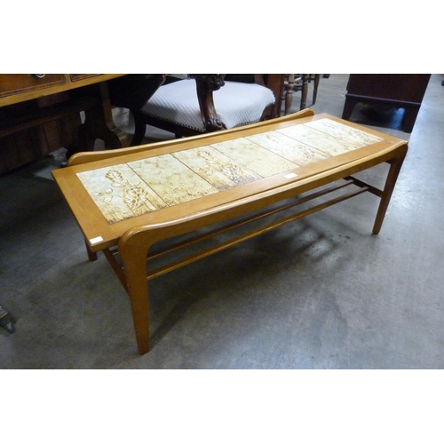 72 - A teak and tiled top coffee table