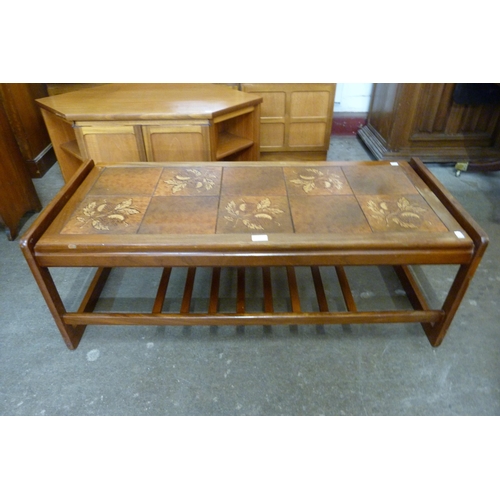73 - A teak and tiled top coffee table