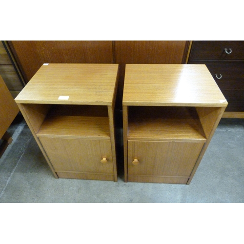 76 - A pair of teak bedside cupboards