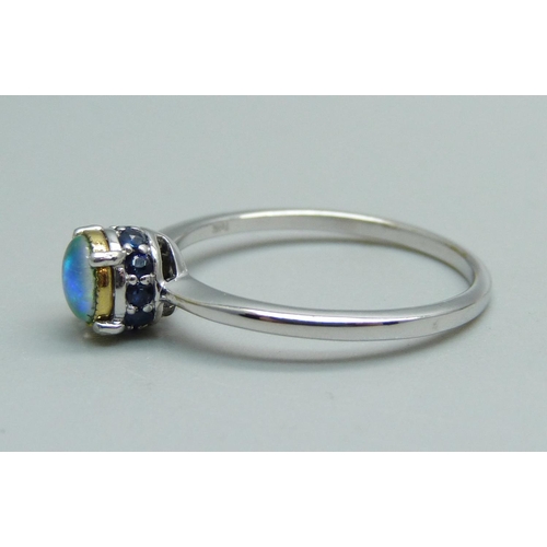 1018 - A 9ct white gold and opal ring set with ten sapphires, 2.1g, Q