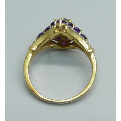 1034 - A silver gilt, amethyst and moonstone ring