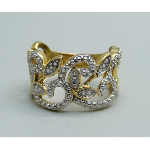 1040 - A pierced silver gilt ring set with a diamond accent, K